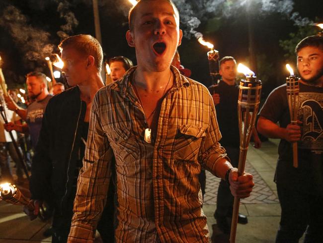 Multiple white nationalist groups march with torches through the University of Virginia campus in Charlottesville on Friday night. Picture: Mykal McEldowney/The Indianapolis Star via AP