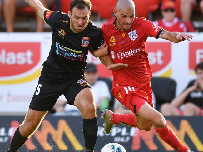 Benjamin Kantarovski of Newcastle Jets competes with Troisi at Coopers Stadium.