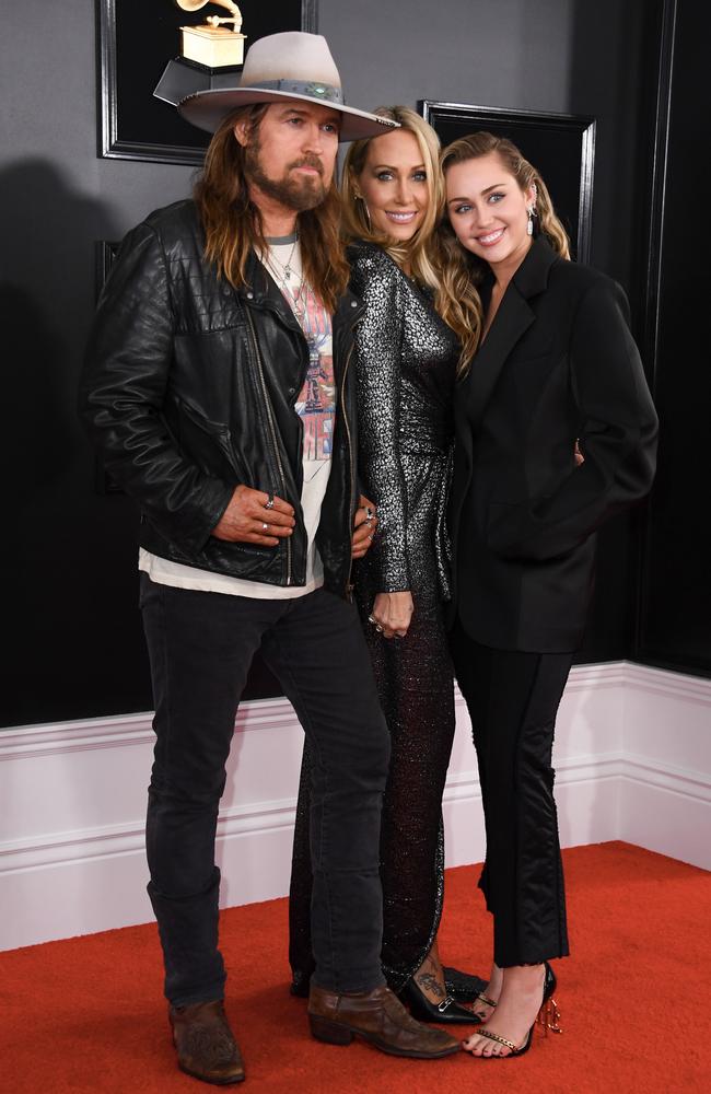 Miley’s dad Billy Ray and mum Tish still follow her... for now. Picture: AFP