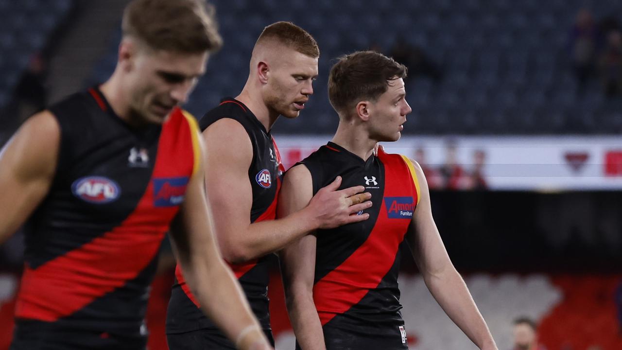 Ridley was consoled by teammate Peter Wright as the Bombers left the field following the 41-point defeat, which could drop them to 12th on the ladder. Picture: Darrian Traynor / Getty Images