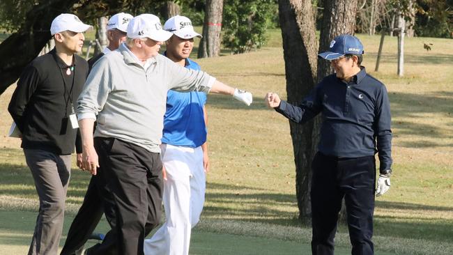 Donald Trump, pictured with Japanese Prime Minister Shinzo Abe (right) while playing golf with Japanese professional golfer Hideki Matsuyama. Picture: AFP