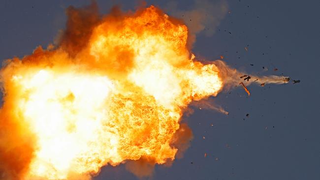 TOPSHOT - This photo taken from a position in northern Israel shows a Hezbollah UAV intercepted by Israeli air forces over north Israel on August 25, 2024. The Israeli military announced early August 25, 2024 that it was conducting pre-emptive strikes in Lebanon after detecting preparations for "large-scale" attacks by the Iran-backed militant group Hezbollah. Hezbollah said August 25, 2024 it had launched more than 320 rockets at Israel overnight, targeting a string of military positions, even as Israel's military said it was carrying out pre-emptive strikes against the group. (Photo by Jalaa MAREY / AFP)