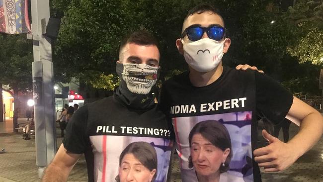 Masked festival goers wearing T-shirts bearing the image of NSW Premier Gladys Berejiklian yesterday.