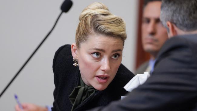 Heard speaking to her lawyer during Wednesday’s proceedings. Picture: Evelyn Hockstein/Pool/AFP