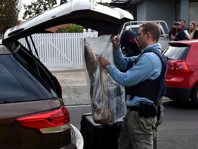 Police collect evidence from a house in Gladstone Park. Picture: Nicole Garmston