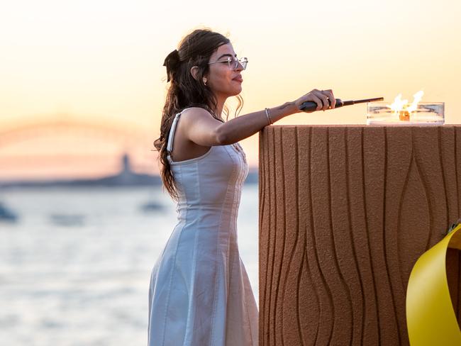 Michal Ohana lights the candle at the Sunset Memorial for 1 year since the attack on the Nova Festival. Picture: Thomas Lisson