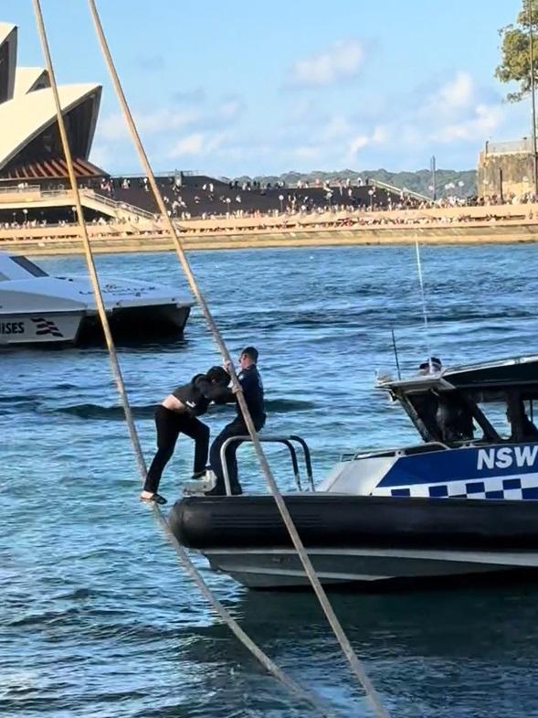 The man was lowered towards the boat, allowing officers to safely pull the man down before placing him under arrest. Image: Supplied/TikTok