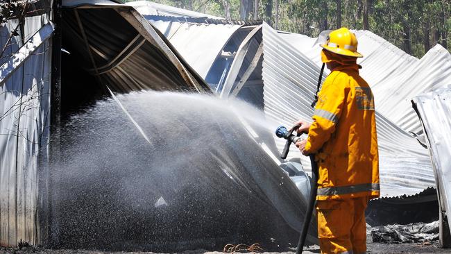 A rural fire fighter extinguishes the remains of a vicious blaze in Glenwood.