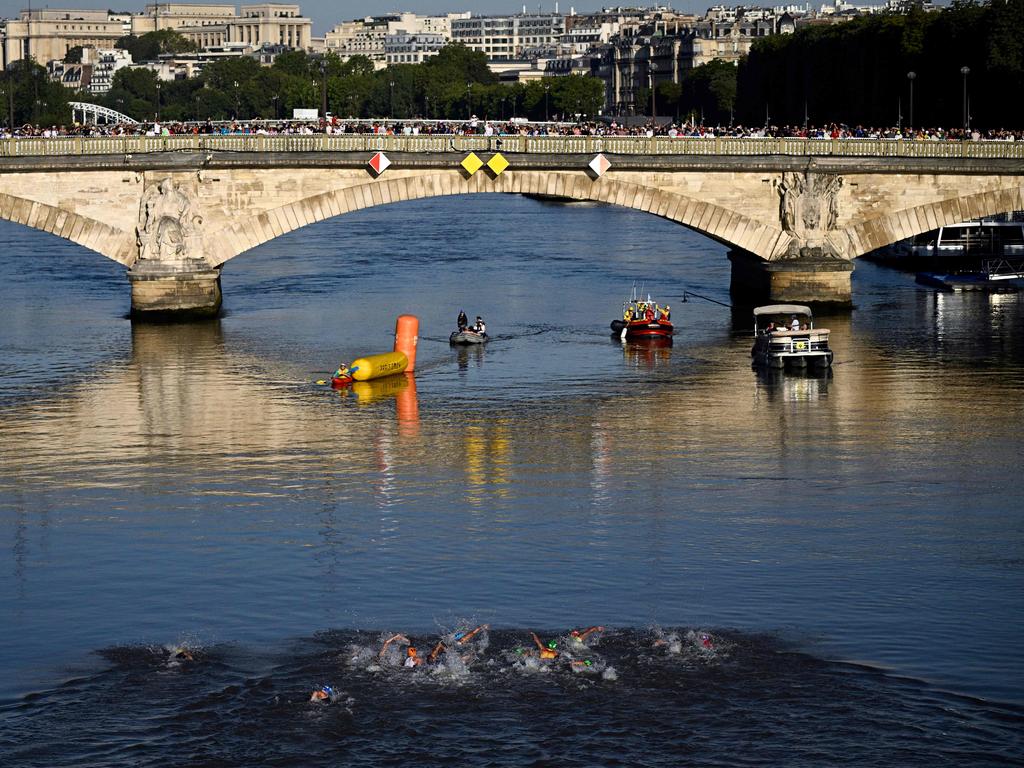 Athletes swimming in the Seine during the mixed relay triathlon. Picture: Julien De Rosa/AFP