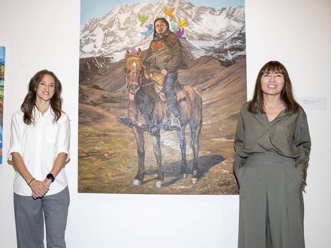Alexis Wildman, senior installation officer and member of the Art Gallery's Packing Room team, and Director of the Art Gallery of New South Wales Maud Page pictured the winning artwork. Picture: Christian Gilles / NewsWire