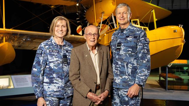 Air Vice-Marshal Glen Braz (right) and Wing Commander Michelle Leigh McPhail presented Mr Mitchell with a replica of the Catalina flying boats he serviced. Picture: Mark Stewart