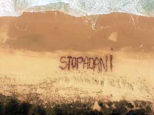 Protesters against plans for Adani's coal mine in Central Queensland make their feelings clear on Peregian Beach. Picture: Eamon Kriz/ In The Air