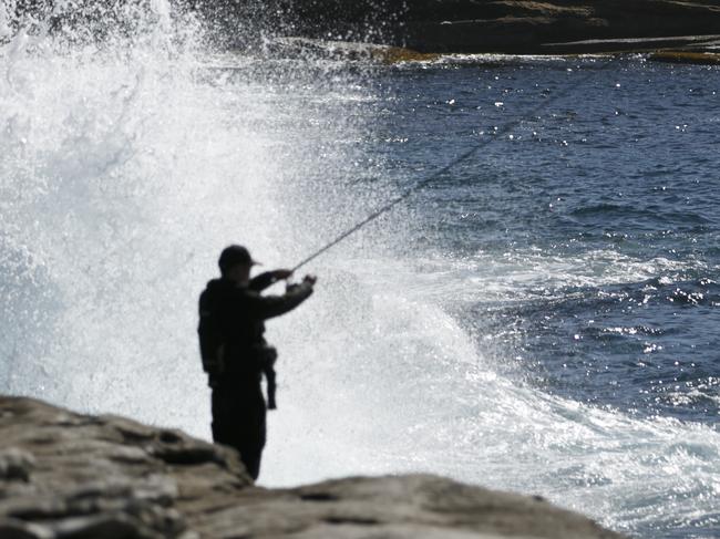 Cape Solander Fisherman off the rocks in dangerous surf in the National Park. Photo: Tim Pascoe