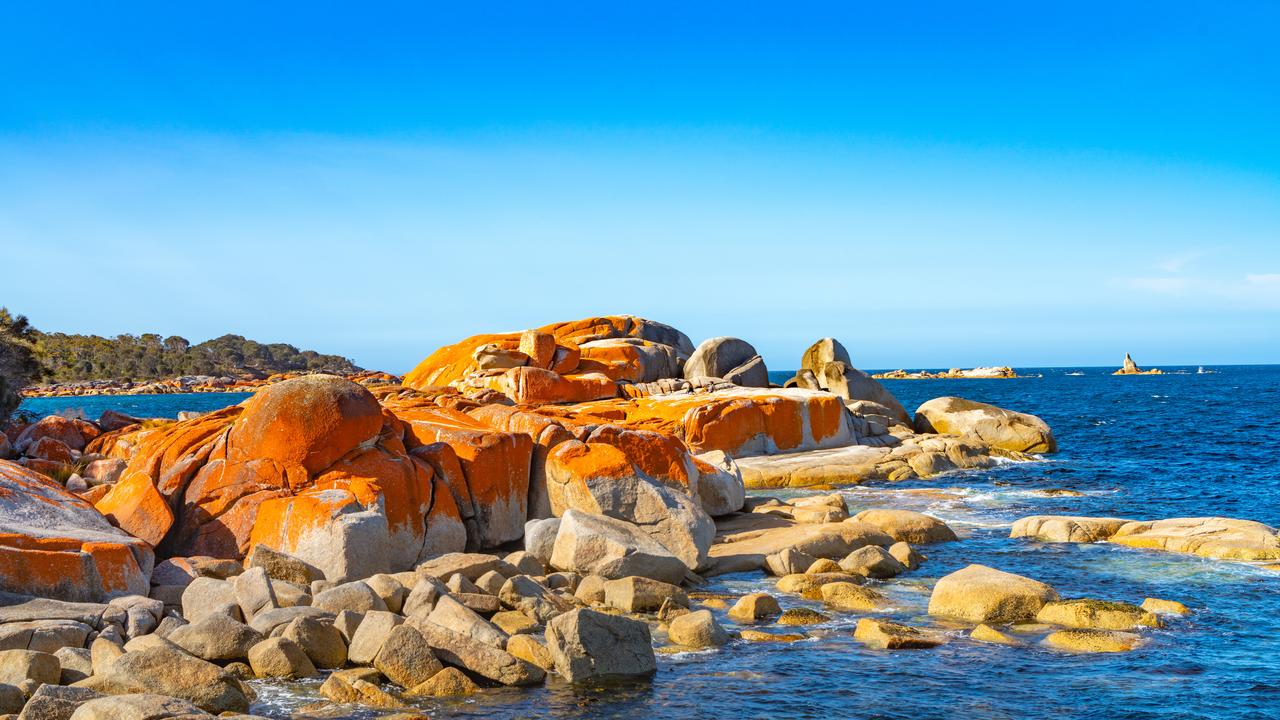 The NYT recommended visiting the “orange lichen covered rocks” of the Bay of Fires. Picture: iStock.