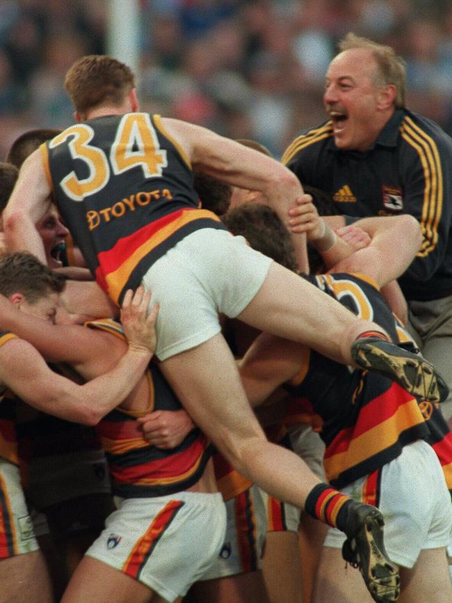 Malcolm Blight jumps on the nest of Crows after the 1998 grand final win. /Football/AFL