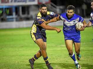 ON THE ATTACK: Wallaroos Shaun Collins fends off the Waves Tukerekere Hikaka. Picture: Brian Cassidy