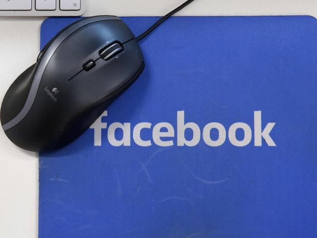 (FILES) This file photo illustration taken on December 4, 2017 shows mousepad with the Facebook logo at Facebook's new headquarters at Rathbone Place in central London. - Facebook was branded "arrogant" and "unconscionable" for banning Australian users from sharing news on February 18, 2021, as its defiant response to government regulation inadvertently crippled the pages of several emergency services. (Photo by Daniel LEAL-OLIVAS / AFP)