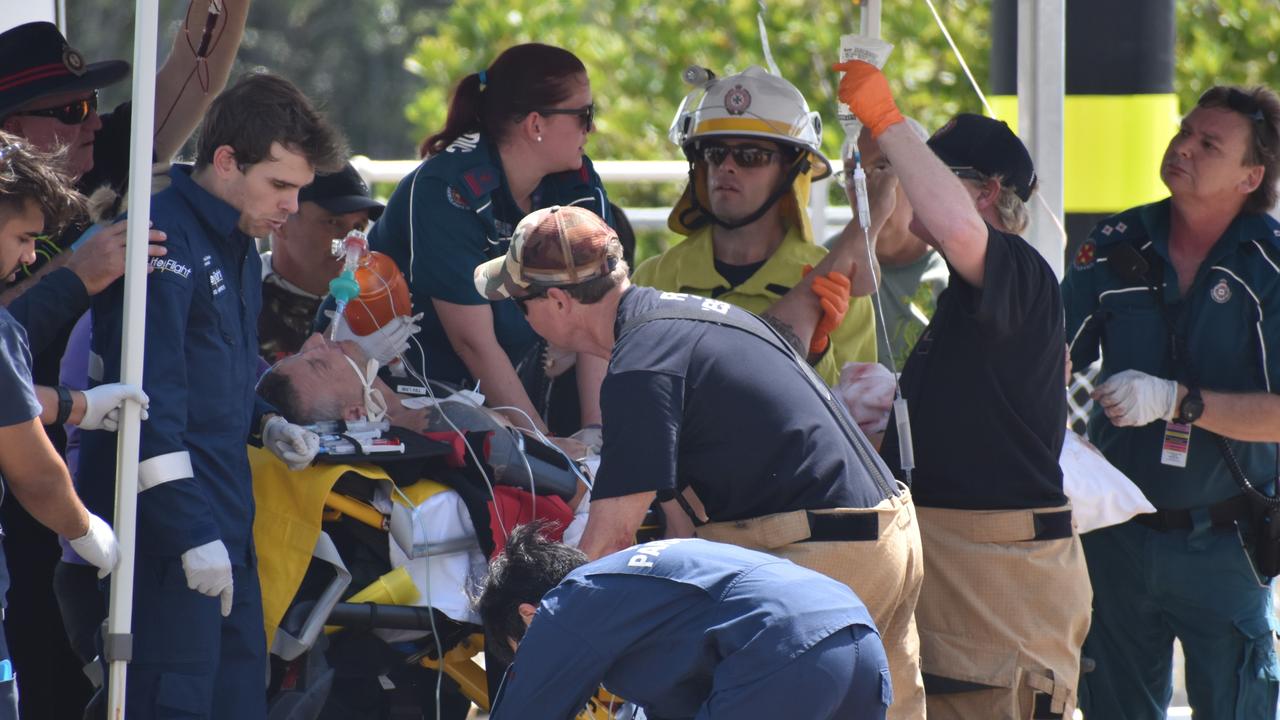 Emergency responders, including Alicia Locke (centre back) work on shark attack victim Rick Bettua at the Dungeness boat ramp in Hinchinbrook. Picture: Cameron Bates