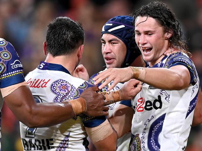 BRISBANE, AUSTRALIA - MAY 27: Nicho Hynes of the Storm is congratulated by team mates after scoring a try during the round 12 NRL match between the Brisbane Broncos and the Melbourne Storm at Suncorp Stadium, on May 27, 2021, in Brisbane, Australia. (Photo by Bradley Kanaris/Getty Images)