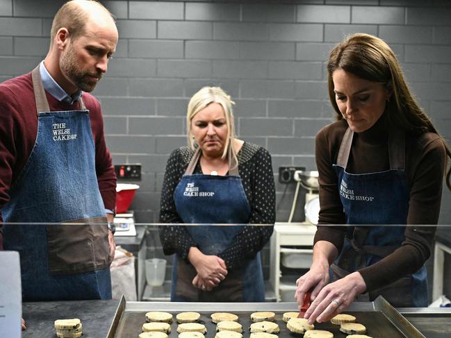 Prince William, Prince of Wales and Theresa Connor, owner of the The Welsh Cake Shop, watch as Britain's Catherine, Princess of Wales places rolled and cut Welsh Cakes. Picture: AFP