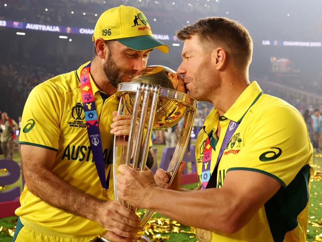 AHMEDABAD, INDIA - NOVEMBER 19: Glenn Maxwell and David Warner of Australia poses with the ICC Men's Cricket World Cup Trophy following the ICC Men's Cricket World Cup India 2023 Final between India and Australia at Narendra Modi Stadium on November 19, 2023 in Ahmedabad, India. (Photo by Robert Cianflone/Getty Images)