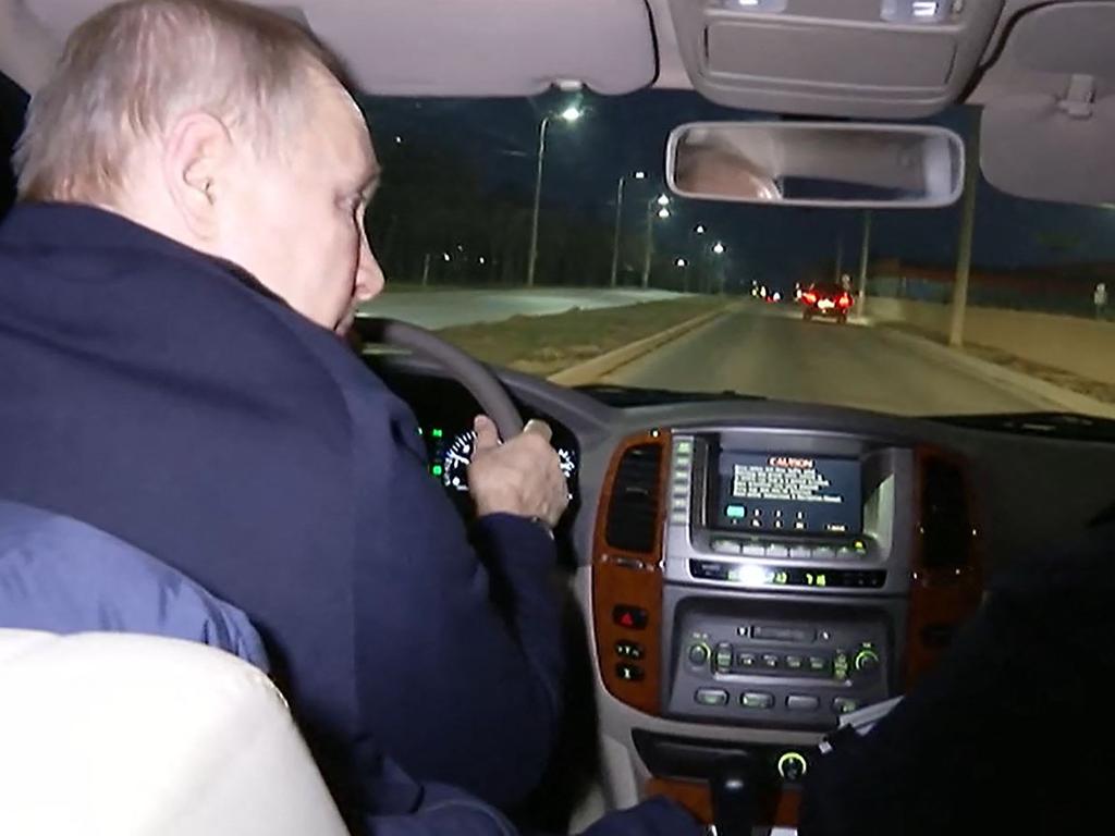 Russian President Vladimir Putin and Russian Deputy Prime Minister Marat Khusnullin (out of frame) driving a car during their visit to Mariupol. Picture: AFP