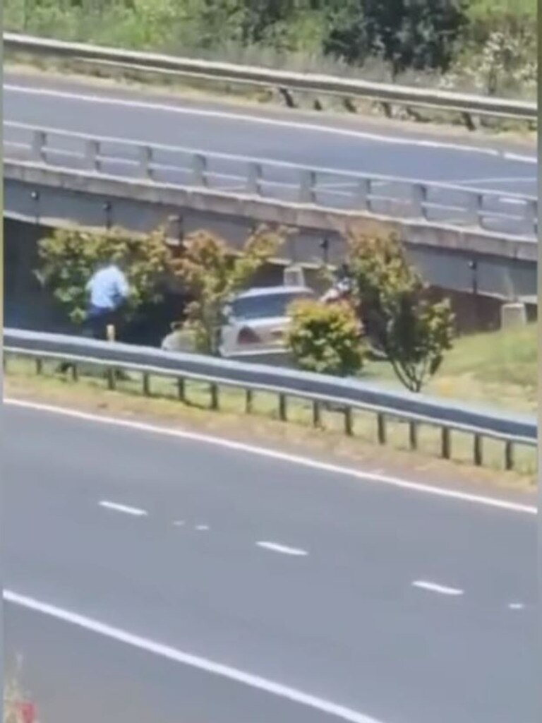 Police officers chased alongside the car before the 33-year-old male drove into a creek in a wild attempt to evade capture. Picture: 9News