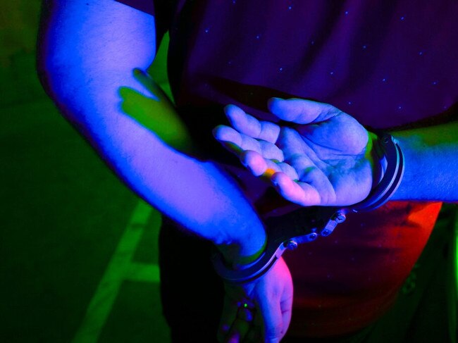 Cairns police generic handcuffs night