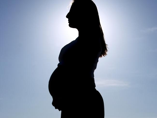 Silhouette of a pregnant woman...sun and nice blue sky behind her.similar image: