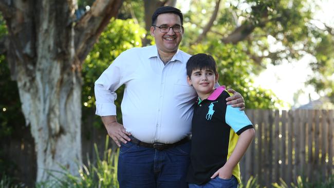 Luay Al-loos, with youngest son Fadi, 13, at their Northmead home in Sydney yesterday, will become a citizen of Australia today. Picture: Britta Campion