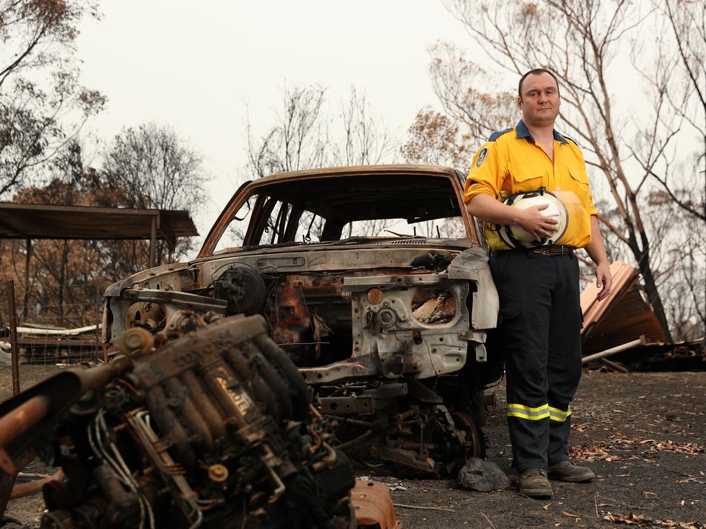 <b>JOHN GALLAGHER, 34</b> <br/> <i>Tathra Rural Fire Brigade<br/>Bega Valley</i> <br/> The screams of five children trapped inside a burning house are what John Gallagher can’t shake when he recalls their terrifying rescue at first light on New Year’s Day. The veteran firefighter received a cluster of triple-0 calls shortly after 6am as residents of the tiny town of Quaama, just inland from Bermagui on the NSW south coast, woke to find the flames at their doorsteps. “The intensity of it caught so many people off guard,” he says. At dawn a firestorm had surrounded the town within minutes and firefighters had been ordered to retreat from the frontline to shelter inside Quaama’s fire station. “Then this call came in for seven people, five of whom were children.” Gallagher and brigade partner Nathan Barnden left the safety of the fire station in a Hyundai Terracan 4WD with “no resources” and drove into the eye of the inferno. “The family’s survival came down to just two firefighters,” he says. “Two streets had already gone up in flames and we were surrounded on both sides of the street by fire.” Operating on “autopilot”, he arrived to find five children, their mother and godmother sheltering in the kitchen. By this time, the house was “fully engulfed” by a wall of flames. “We jumped out and proceeded to the first door we could find,” Gallagher says. “I was yell­ing and screaming as much as I could. They came out barefoot with no shirts on and they ran across the burning ground to our vehicle.” Gallagher and Barnden ordered the children to stay below the car’s windows as fire lapped at the vehicle, melting the plastic on the doors. “All I could think about was getting this family back to the fire station.” Still in their Terracan, the two fireys saved six more people from burning homes that day. All up, 13 people owe their lives to Gallagher and Barnden. Picture: Jonathan Ng