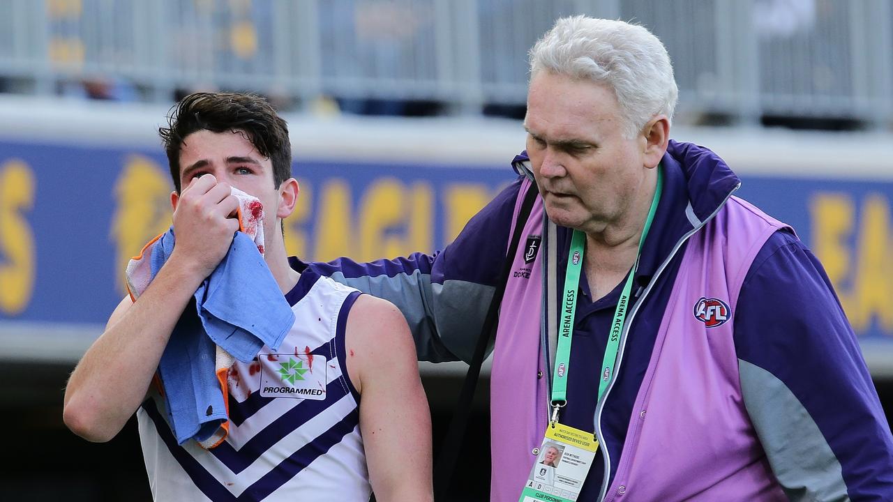 Andrew Brayshaw leaves the field with a suspected broken jaw. (Photo by Will Russell/AFL Media/Getty Images)