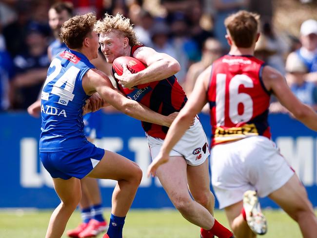 MELBOURNE, AUSTRALIA - FEBRUARY 22: Clayton Oliver of the Demons evades Tom Powell of the Kangaroos during the 2025 AFL match simulation between the North Melbourne Kangaroos and Melbourne Demons at Arden Street on February 22, 2025 in Melbourne, Australia. (Photo by Dylan Burns/AFL Photos via Getty Images)