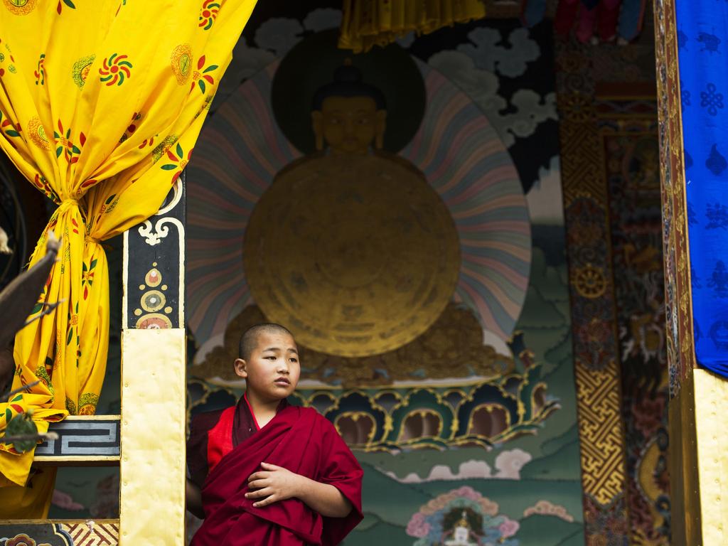 A young Bhuddist monk stands in the entrance of a temple inside the Tashichho Dzong, a fortress and Bhuddist monastery, where the King of Bhutan Jigme Khesar Namgyel Wangchuck has an office and where several bhutanese government ministries are located on April 13, 2016. Picture: AFP