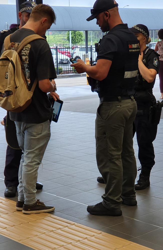 Police check IDs and tickets of young teenagers.