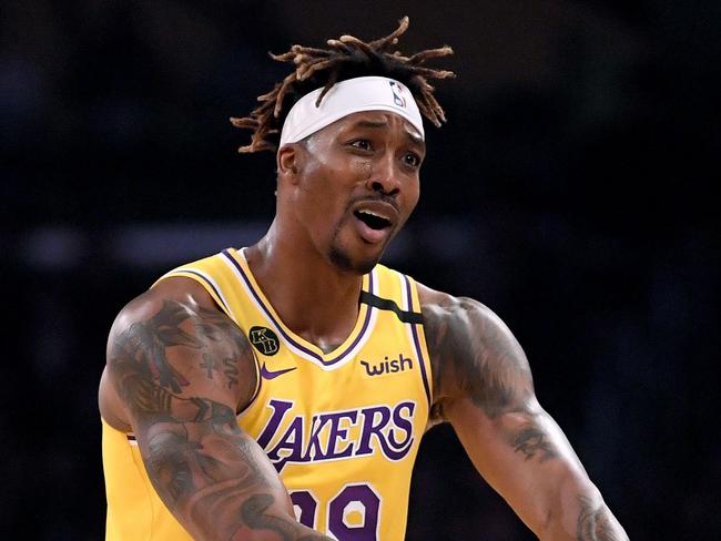 (FILES) In this file photo Dwight Howard #39 of the Los Angeles Lakers argues his foul call with referee David Guthrie #16 during the first quarter at Staples Center on February 21, 2020 in Los Angeles, California. - Los Angeles Lakers center Dwight Howard says he will play when the NBA season resumes in Orlando on July 30, 2020 despite concerns the restart might distract from his social activism. Howard announced his decision to join LeBron James and his other Laker teammates in a CNN appearance late Monday, citing his contract and his hunger to win an NBA crown at age 34. (Photo by Harry How / GETTY IMAGES NORTH AMERICA / AFP)