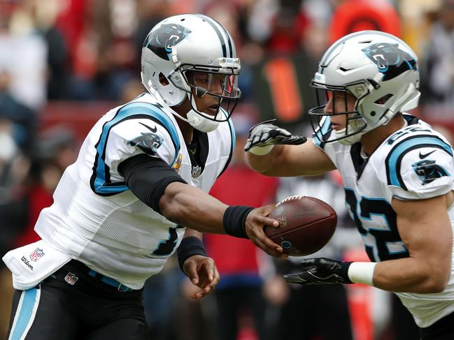 Carolina Quarterback Cam Newton #1 hands the ball off to running back Christian McCaffrey #22. Picture: Getty Images