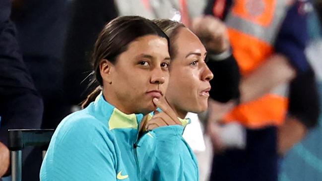 Australia's forward #20 Sam Kerr (L) observes from the sidelines after being ruled out from the Australia and New Zealand 2023 Women's World Cup Group B football match between Australia and Ireland due to injury at Stadium Australia, also known as Olympic Stadium, in Sydney on July 20, 2023. (Photo by DAVID GRAY / AFP)