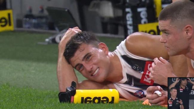 Nick Daicos receiving treatment on the bench.
