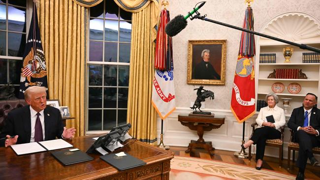 White House chiefs of Staff Susie Wiles and Dan Scavino watch as US President Donald Trump speaks to journalists from the Oval Office. Picture: AFP