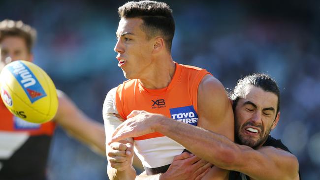 Dylan Shiel clears as he is tackled by Brodie Grundy. Picture: Michael Klein