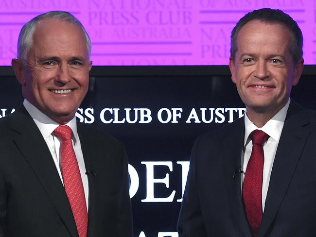 Prime Minister Malcolm Turnbull, left, and Opposition Leader Bill Shorten shake hands as they arrive for the leaders' debate at the National Press Club in Canberra, Sunday, May, 29, 2016. Australia will go to the polls on July 2, 2016 to elect a new prime minister after the Governor-General was asked to dissolve both houses of Parliament and call a full election.(AP Photo/Tracey Nearmy, Pool)