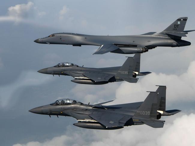 A US Air Force B-1B Lancer (top) being joined by Republic of Korea air force F-15s, during a 10-hour mission from Andersen Air Force Base, Guam, into Japanese airspace and over the Korean Peninsula. American forces on July 30. Picture: AFP