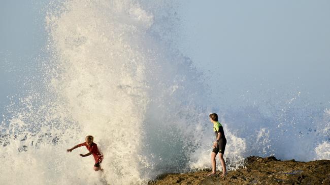Young swimmers knocked down by swell at Snapper Rocks on the Gold Coast generated by Tropical Cyclone Oma. Photo: Mark Furler.