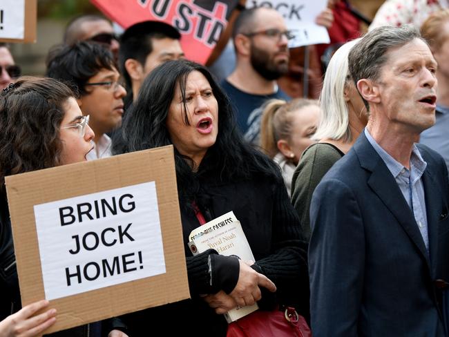 Supporters are seen holding placards during a rally to free Jock Palfreeman at Sydney Town Hall in Sydney last week. Picture: AAP