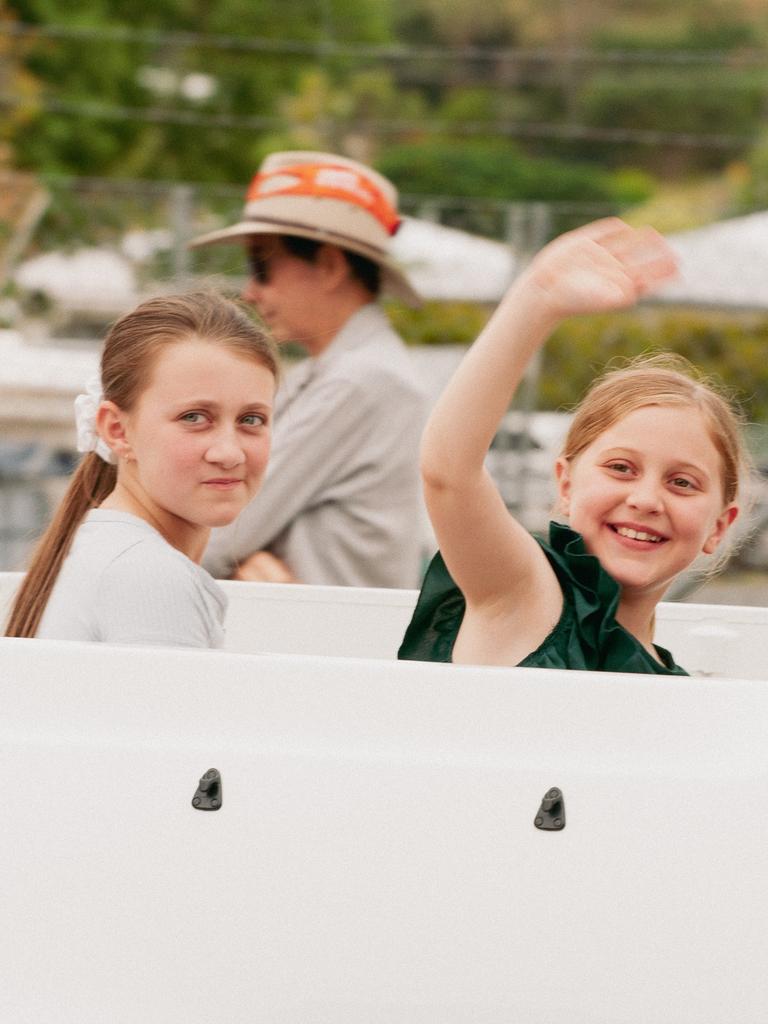 Young parade riders wave to the crowd at the 2023 Gayndah Orange Festival.