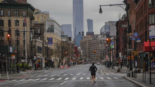 A lone jogger runs down a partially empty 7th Avenue in New York. Picture: AP