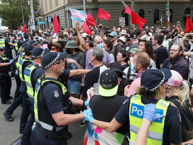 Police try to control crowds at the rally. Picture: David Crosling