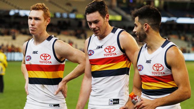 MELBOURNE, AUSTRALIA - JULY 30: Mitchell McGovern (C) of the Crows walks off with Tom Lynch (L) and Wayne Milera after he to sealed a draw during the round 19 AFL match between the Collingwood Magpies and the Adelaide Crows at Melbourne Cricket Ground on July 30, 2017 in Melbourne, Australia. (Photo by Michael Dodge/Getty Images)