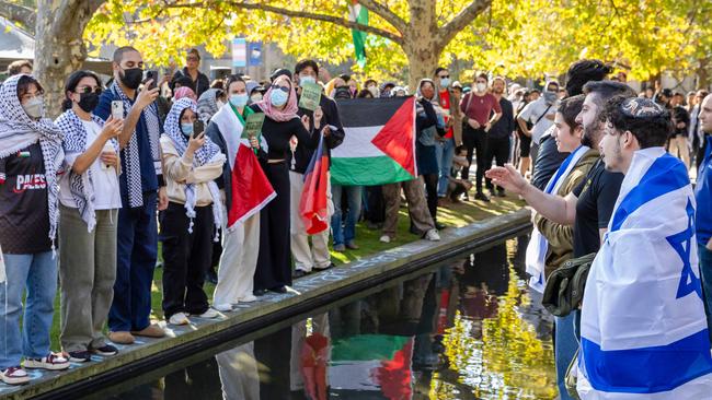 Jewish Israel supporters assemble in a park near Melbourne University before confronting pro-Palestinian protesters on campus. The two groups faced off amid ongoing tensions surrounding the conflict in Gaza. Picture: Jason Edwards